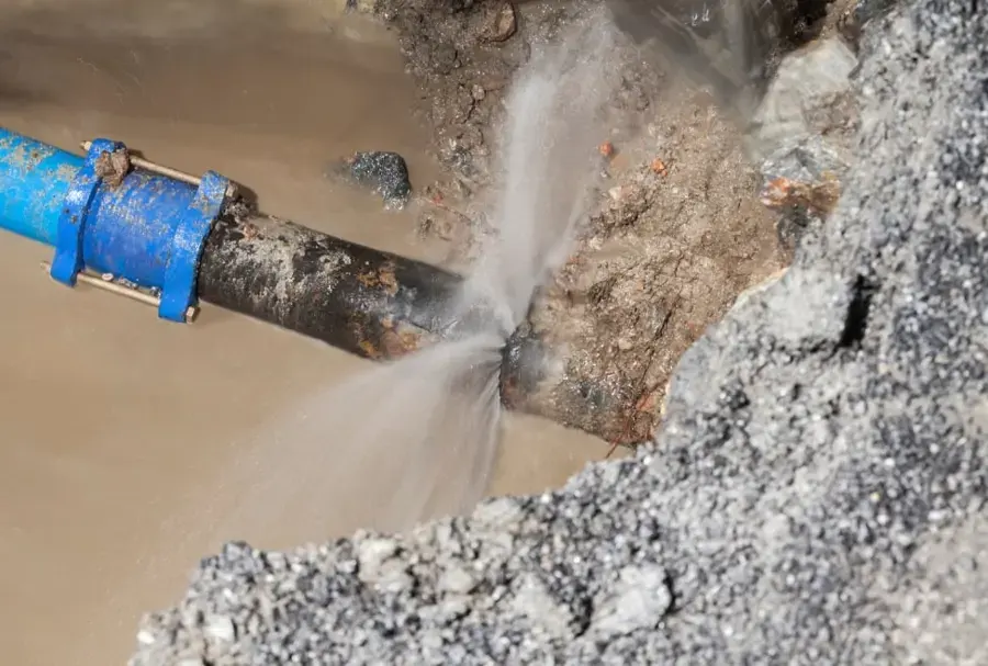 Water spraying from a split in a supply pipe